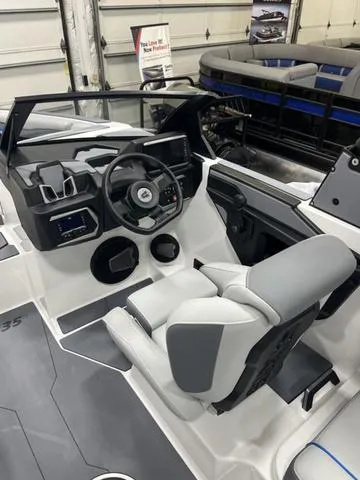 Slide: The Image of 2024 Axis Wake Research T235 boat interior with modern dashboard and seating. - 7