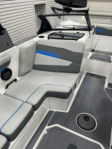 Slide: The Image of 2024 Axis Wake Research T235 boat interior with gray and blue seating. - 9