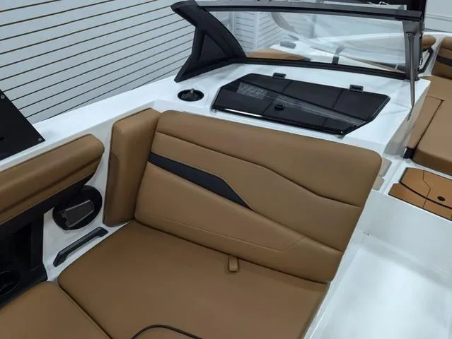 Slide: The Image of 2025 Axis Wake Research T220 boat interior with tan leather seating and sleek design. - 10
