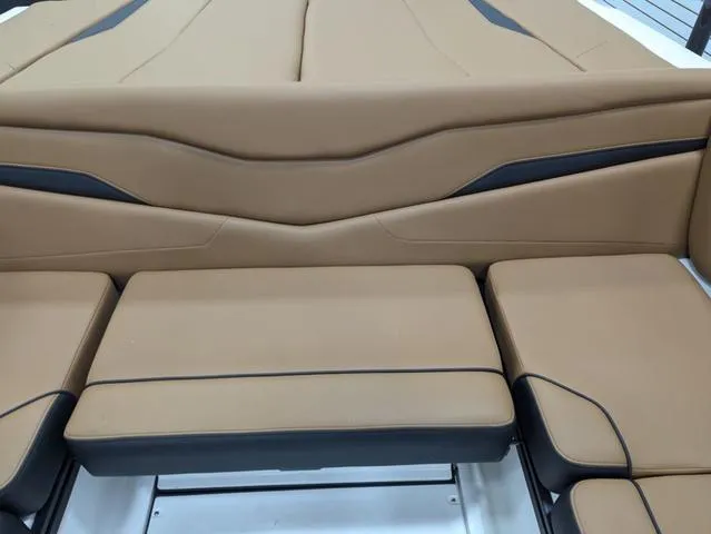 Slide: The Image of 2025 Axis Wake Research T220 boat interior with tan and black seating. - 12