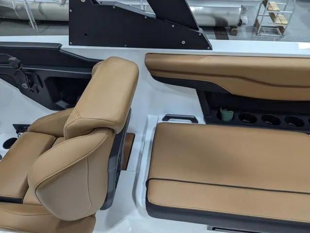 Slide: The Image of 2025 Axis Wake Research T220 boat interior with tan seating and modern design. - 13