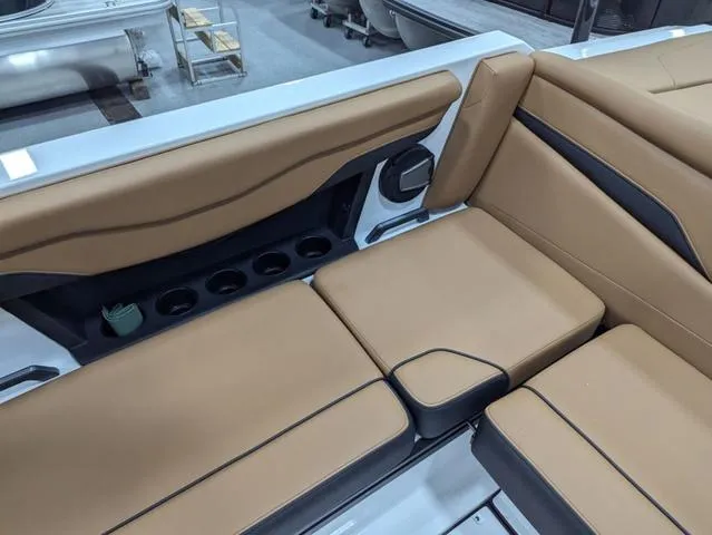 Slide: The Image of 2025 Axis Wake Research T220 boat interior with tan seating and cup holders. - 15