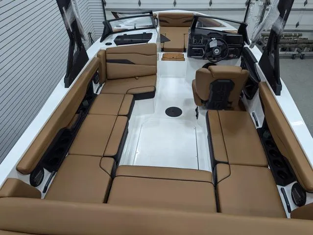 Slide: The Image of 2025 Axis Wake Research T220 boat interior with tan seating and modern dashboard. - 5