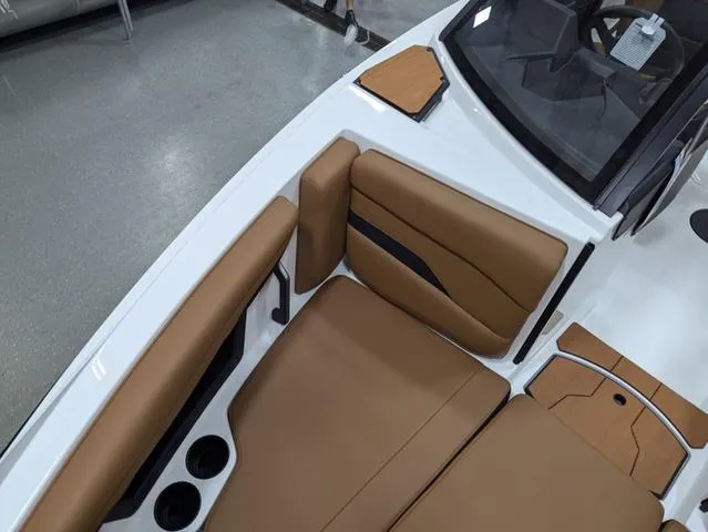 Slide: The Image of 2025 Axis Wake Research T220 boat interior with tan seating and cup holders. - 7
