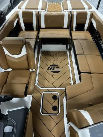 Slide: The Image of 2024 Malibu 22 LSV boat interior with brown and white seating, stylish design. - 13