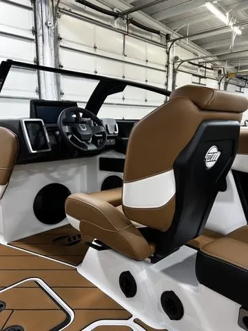 Slide: The Image of 2024 Malibu 22 LSV boat interior with brown leather seats and modern dashboard. - 14