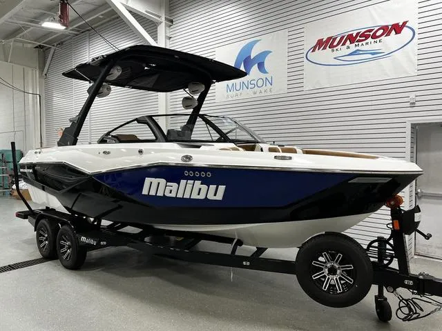 Slide: The Image of 2024 Malibu 22 LSV boat in showroom, featuring sleek design and modern features. - 2