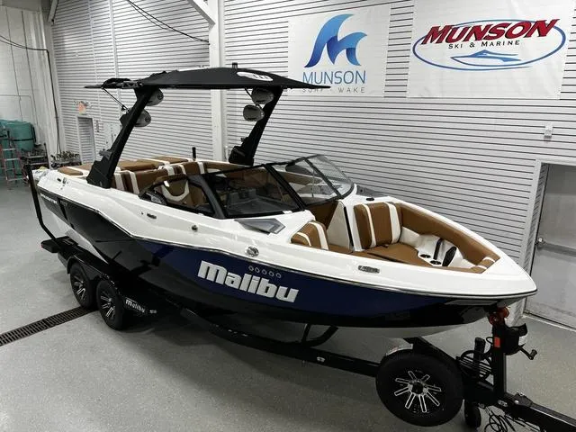 Slide: The Image of 2024 Malibu 22 LSV boat in showroom, featuring sleek design and modern interior. - 3