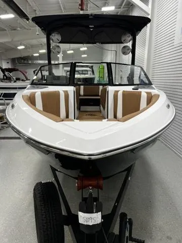 Slide: The Image of 2024 Malibu 22 LSV boat with sleek design and spacious interior, displayed indoors. - 4