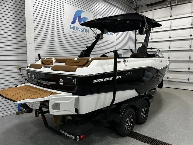 Slide: The Image of 2024 Malibu 22 LSV boat in showroom, featuring sleek design and modern amenities. - 5