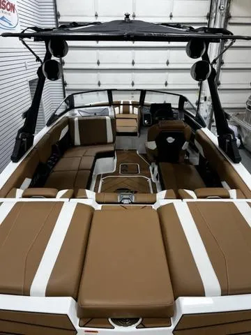 Slide: The Image of 2024 Malibu 22 LSV boat interior with brown and white seating, sleek design, and modern features. - 7