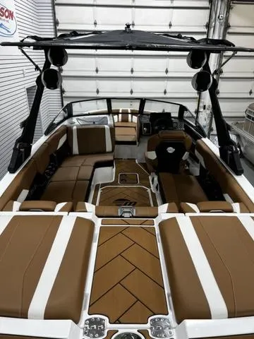 Slide: The Image of 2024 Malibu 22 LSV boat interior with brown and white seating, sleek design. - 8