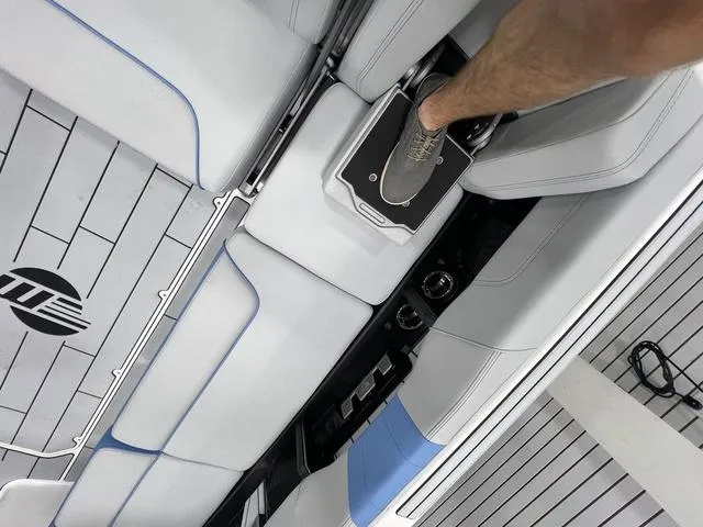 Slide: The Image of 2024 Malibu 24 MXZ boat interior with sleek seating and footrest. - 8