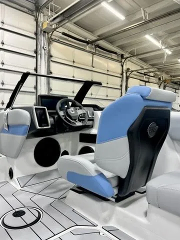 Slide: The Image of 2024 Malibu 21 LX boat interior with modern dashboard and blue-gray seating. - 10