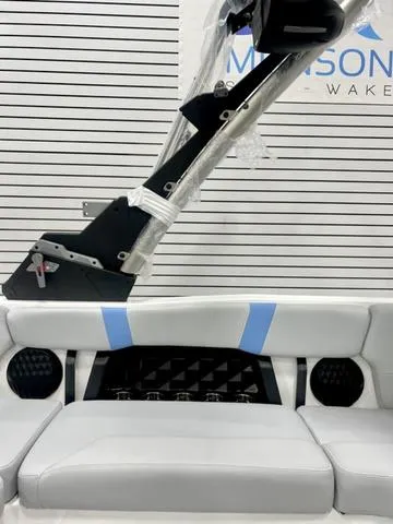 Slide: The Image of 2024 Malibu 21 LX boat interior with sleek seating and modern design elements. - 12