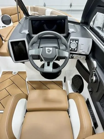 Slide: The Image of 2024 Malibu 22 LSV boat interior with modern dashboard and steering wheel. - 13