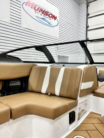 Slide: The Image of 2024 Malibu 22 LSV boat interior with tan and white seating at Munson Ski & Marine. - 15