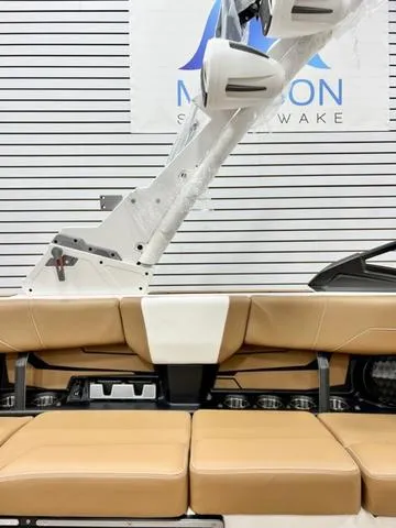 Slide: The Image of 2024 Malibu 22 LSV boat interior with tan seating and sleek design. - 16