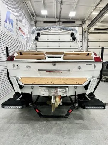 Slide: The Image of 2024 Malibu 22 LSV boat in showroom, rear view with sleek design and modern features. - 4