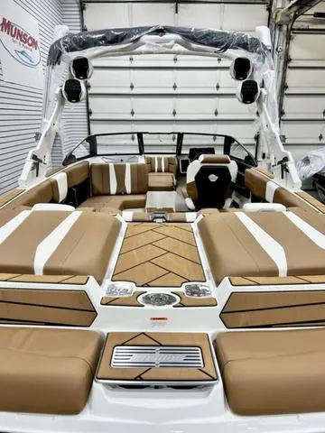 Slide: The Image of 2024 Malibu 22 LSV boat interior with tan and white seating, showcasing luxury and style. - 6