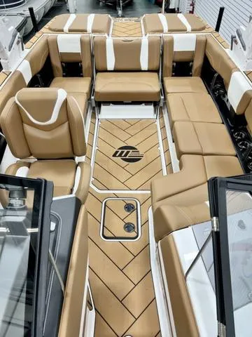 Slide: The Image of 2024 Malibu 22 LSV boat interior with tan seating and stylish flooring. - 9