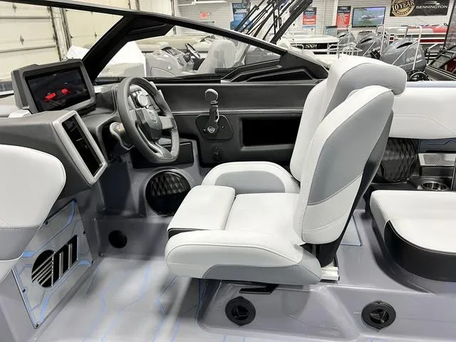 Slide: The Image of 2024 Malibu 23 MXZ boat interior with modern dashboard and comfortable seating. - 12