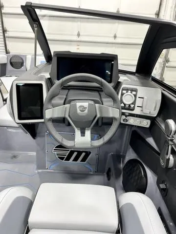 Slide: The Image of 2024 Malibu 23 MXZ boat dashboard with modern controls and sleek design. - 13