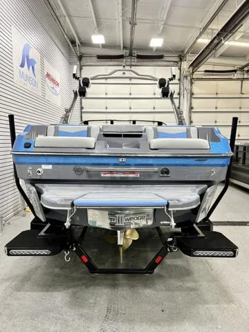 Slide: The Image of 2024 Malibu 23 MXZ boat in a garage, showcasing rear design and features. - 4