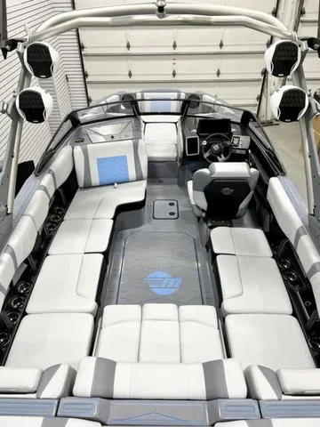 Slide: The Image of 2024 Malibu 23 MXZ boat interior with luxurious seating and modern dashboard. - 5