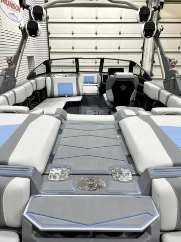 Slide: The Image of 2024 Malibu 23 MXZ boat interior with luxurious seating and modern design. - 7