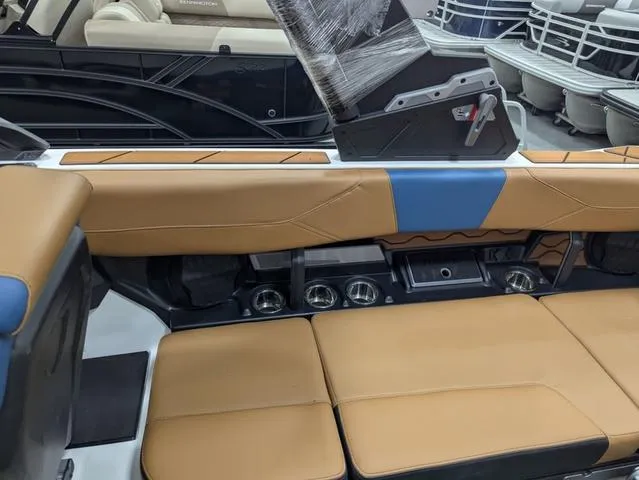 Slide: The Image of 2025 Malibu 23 LSV boat interior with tan and blue seating, showcasing modern design. - 13