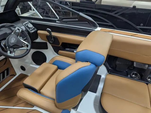 Slide: The Image of Interior of 2025 Malibu 23 LSV boat with tan and blue seating. - 14