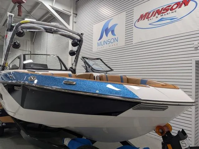 Slide: The Image of 2025 Malibu 23 LSV boat displayed at Munson Ski & Marine showroom. - 3