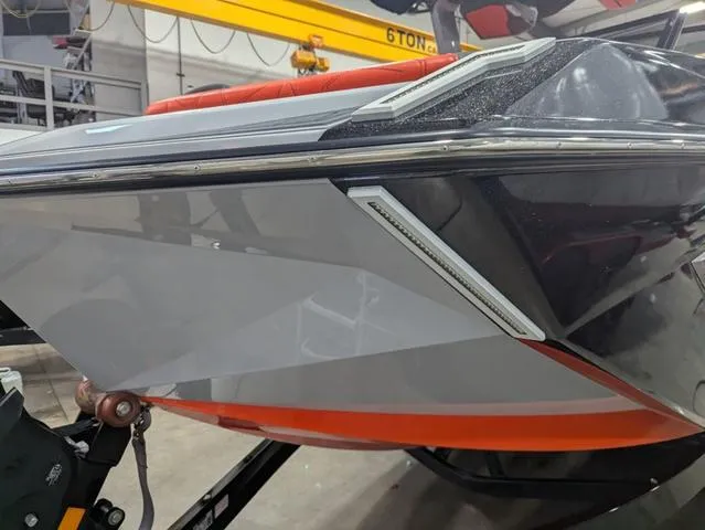 Slide: The Image of 2020 Nautique G23 Paragon boat with sleek design in a workshop setting. - 10