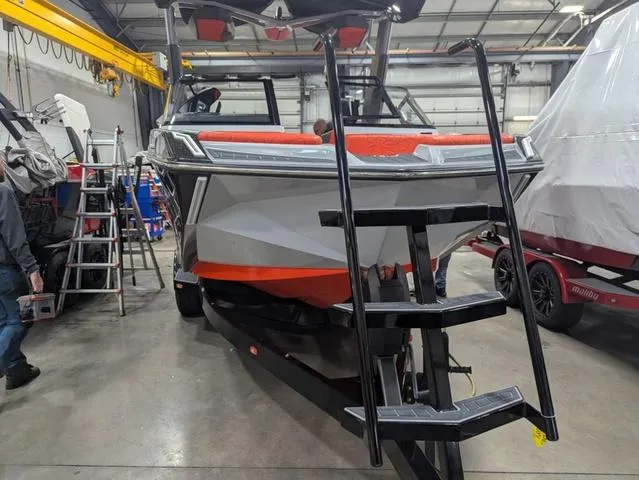 Slide: The Image of 2020 Nautique G23 Paragon boat in a garage, front view with ladder. - 16