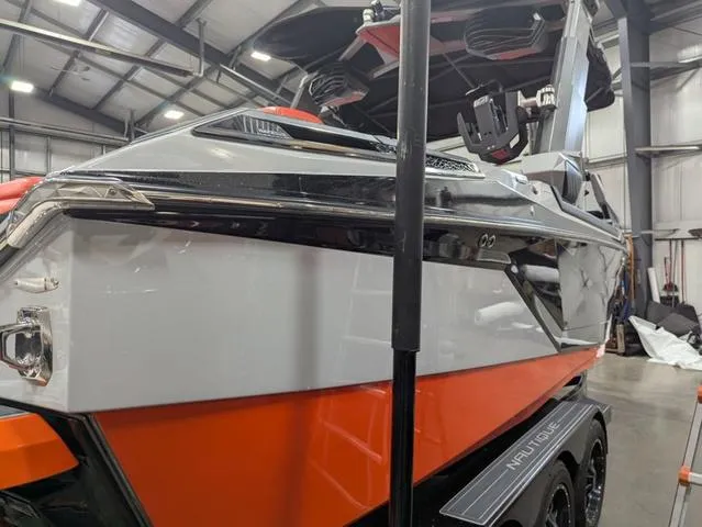 Slide: The Image of 2020 Nautique G23 Paragon boat in a warehouse, showcasing sleek design and vibrant colors. - 17