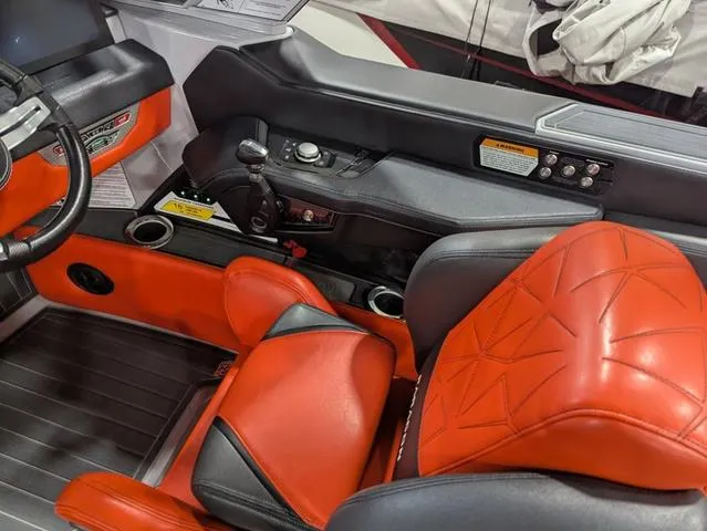 Slide: The Image of 2020 Nautique G23 Paragon cockpit with red leather seats and modern controls. - 18