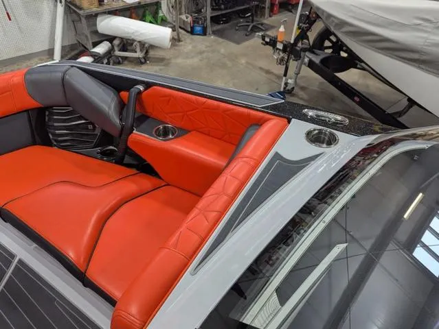 Slide: The Image of 2020 Nautique G23 Paragon interior with red and gray seating, cup holders, and sleek design. - 19