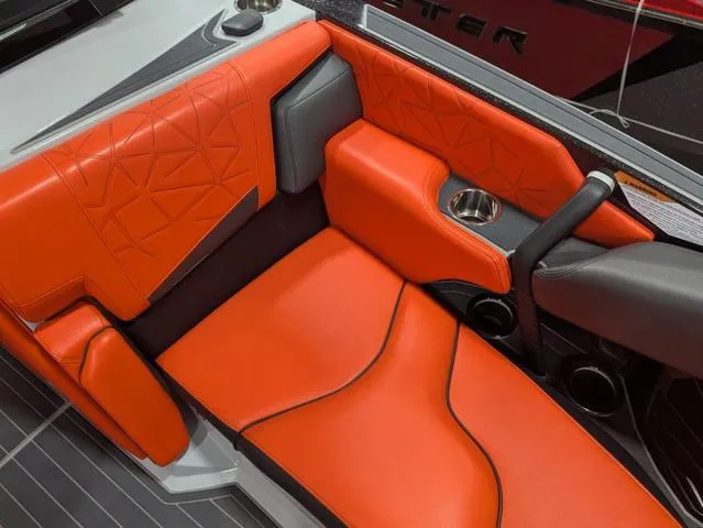 Slide: The Image of 2020 Nautique G23 Paragon interior with orange upholstery and cup holder. - 21