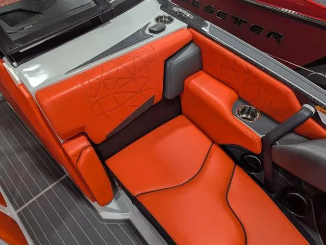 Slide: The Image of 2020 Nautique G23 Paragon interior with vibrant orange seating and cup holder. - 37