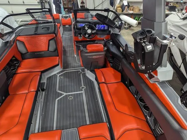 Slide: The Image of 2020 Nautique G23 Paragon interior with red seating and modern dashboard. - 39