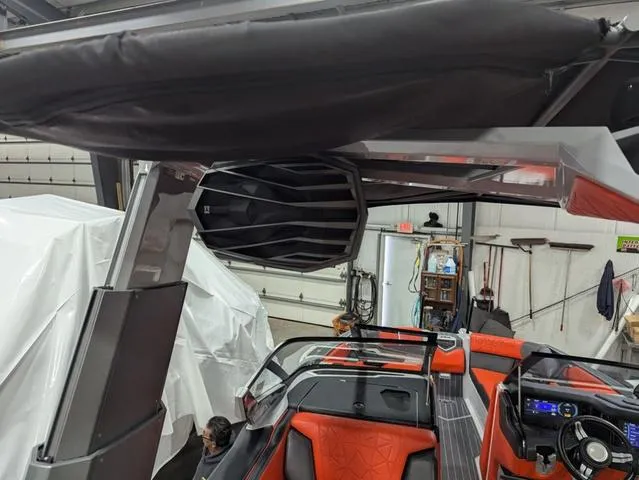 Slide: The Image of 2020 Nautique G23 Paragon boat interior with red seating and advanced sound system. - 40