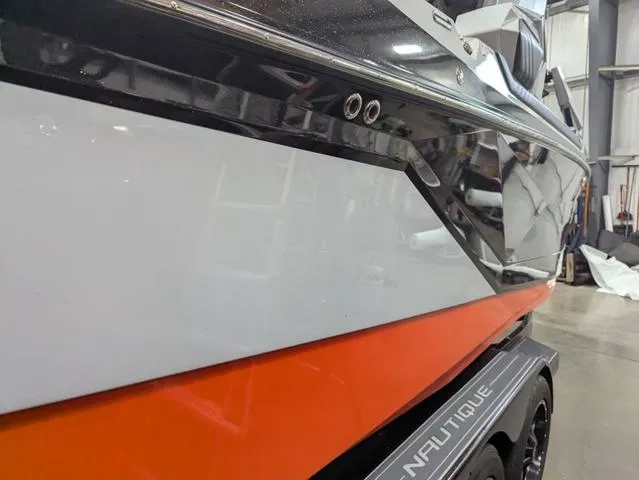 Slide: The Image of 2020 Nautique G23 Paragon boat in a showroom, featuring sleek design and vibrant colors. - 7