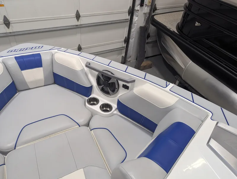 Slide: The Image of Interior of 2021 Malibu Wakesetter 20 VTX boat with blue and white seating. - 16