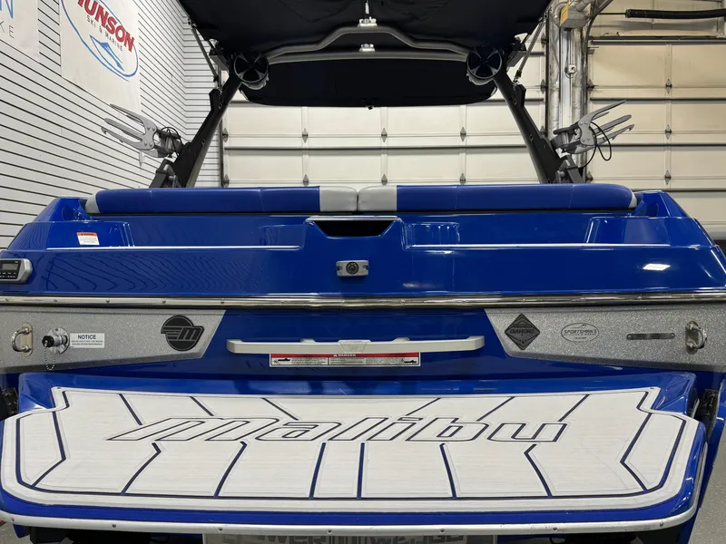 Slide: The Image of 2021 Malibu Wakesetter 20 VTX boat, blue exterior, rear view in garage setting. - 4