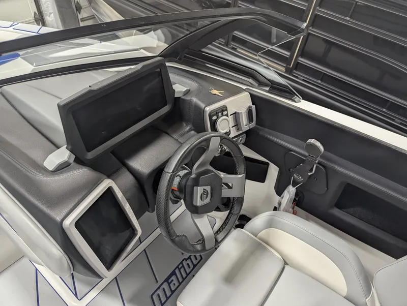 Slide: The Image of 2021 Malibu Wakesetter 20 VTX boat dashboard with steering wheel and control panels. - 8