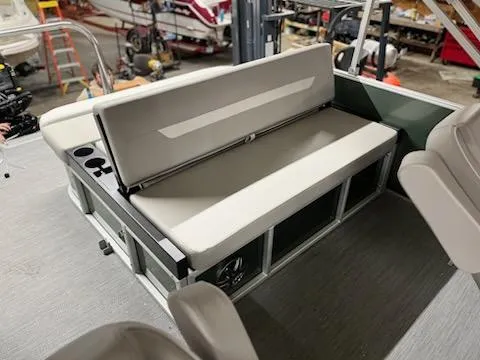 Slide: The Image of 2025 Godfrey 2286SFLX boat interior with cushioned seating and cup holders. - 13