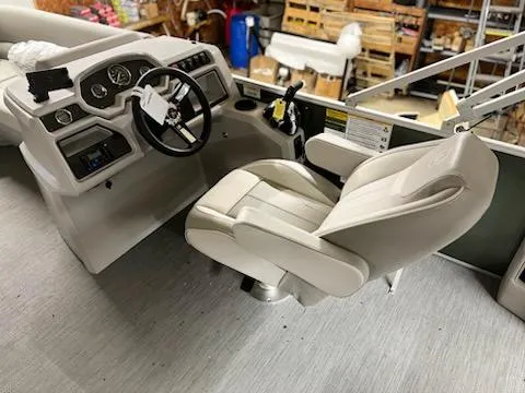 Slide: The Image of 2025 Godfrey 2286SFLX boat interior with steering wheel and captain's chair. - 15