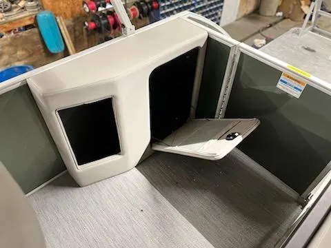 Slide: The Image of Interior of a 2025 Godfrey 2286SFLX boat, featuring a storage compartment. - 17