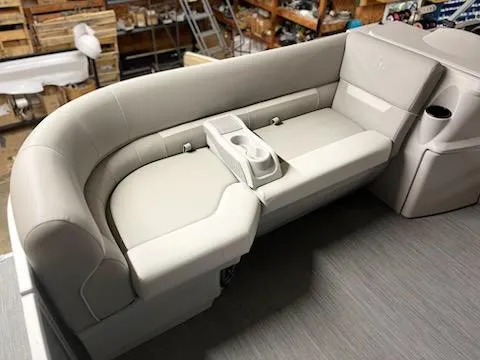 Slide: The Image of Luxurious seating on 2025 Godfrey 2286SFLX boat, featuring beige upholstery and cup holders. - 19